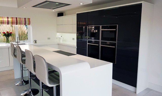 A Metz Gloss White And Gloss Graphite Kitchen With Corian Worktops