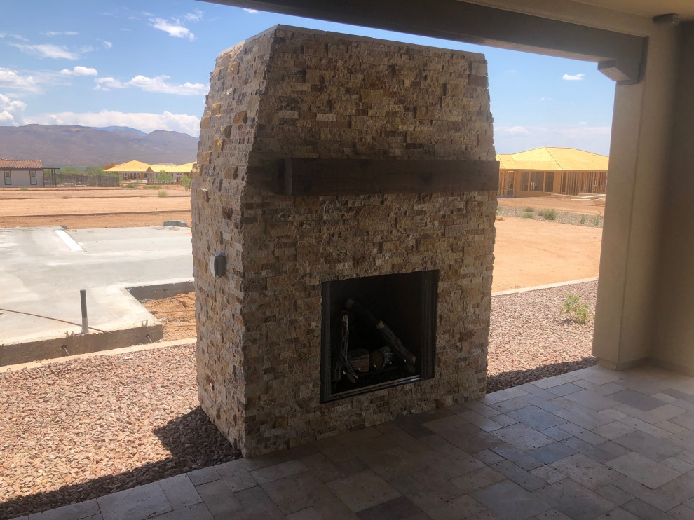Large transitional backyard stone patio photo in Phoenix with a fireplace