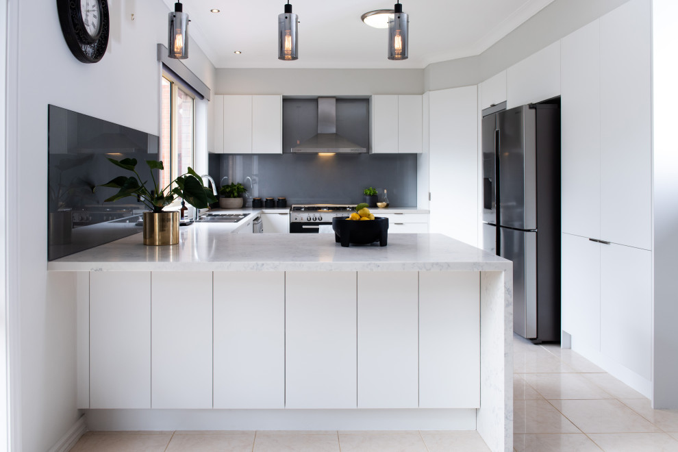 Design ideas for a large modern u-shaped kitchen pantry in Melbourne with an undermount sink, open cabinets, white cabinets, quartz benchtops, grey splashback, glass sheet splashback, stainless steel appliances, porcelain floors, with island, white floor and grey benchtop.