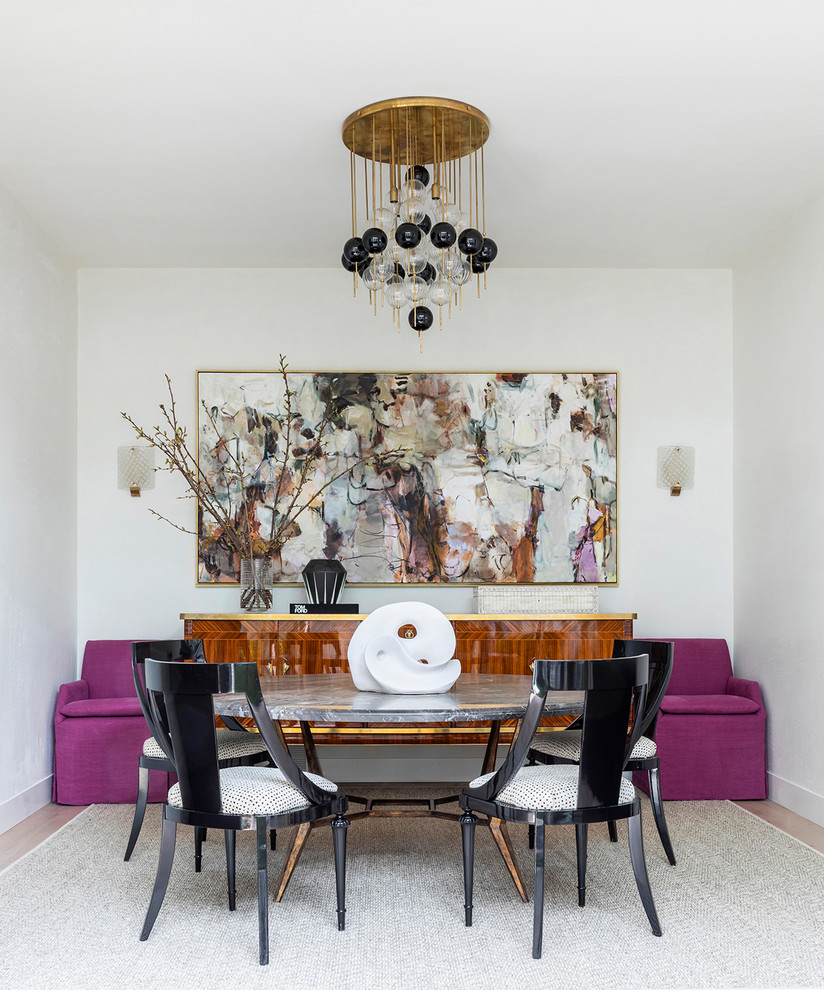 This is an example of a contemporary dining room in Houston with white walls, medium hardwood floors and brown floor.