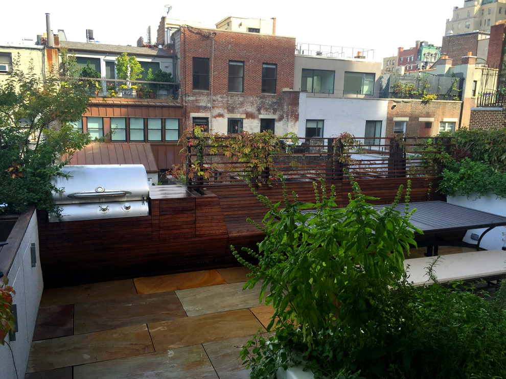 Design ideas for a mid-sized contemporary rooftop deck in New York with an awning.