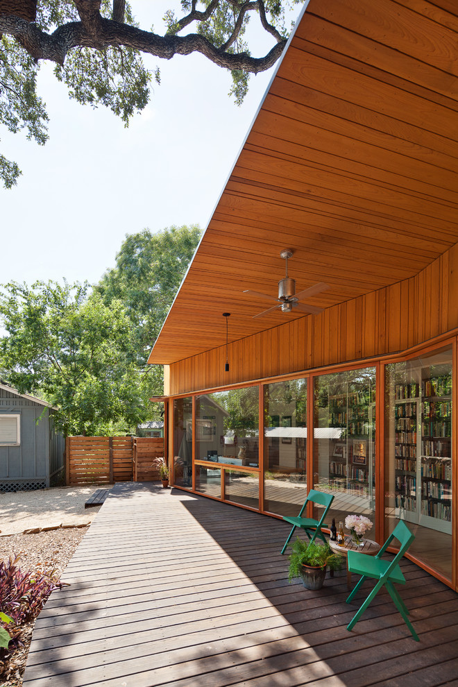 Photo of a contemporary deck in Austin with a roof extension.