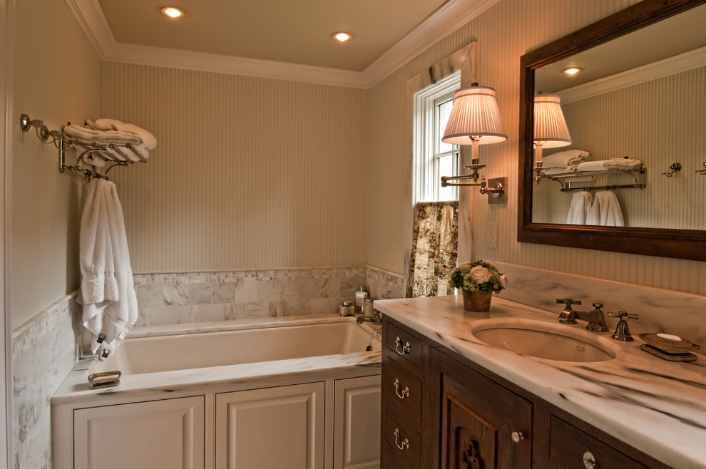 Inspiration for a large transitional master bathroom in Nashville with an undermount sink, furniture-like cabinets, medium wood cabinets, onyx benchtops, a japanese tub, a one-piece toilet, white tile, mosaic tile, white walls and ceramic floors.