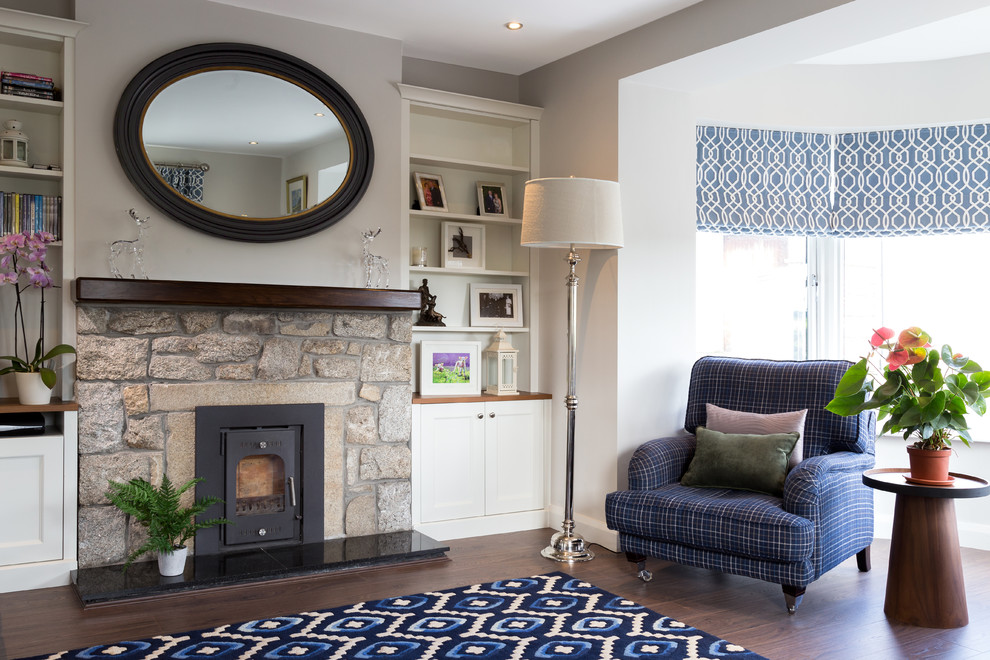 Photo of a transitional living room in Dublin with a stone fireplace surround.