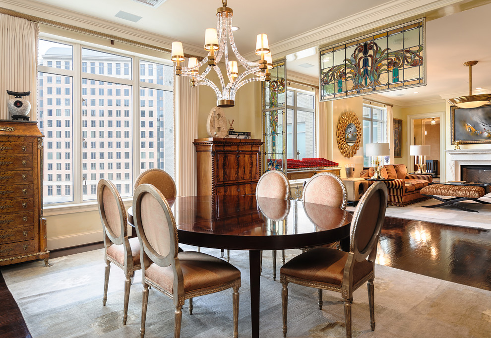 Photo of a traditional dining room in Dallas with beige walls and dark hardwood floors.
