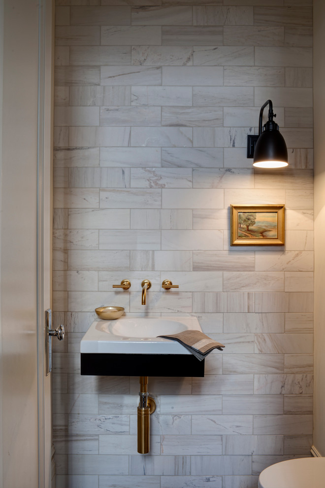 Transitional powder room in Chicago with a wall-mount sink and marble.