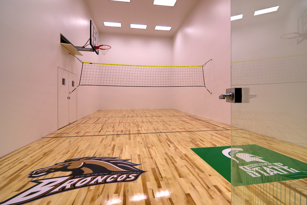 This is an example of an expansive traditional indoor sport court in Grand Rapids with white walls and light hardwood floors.