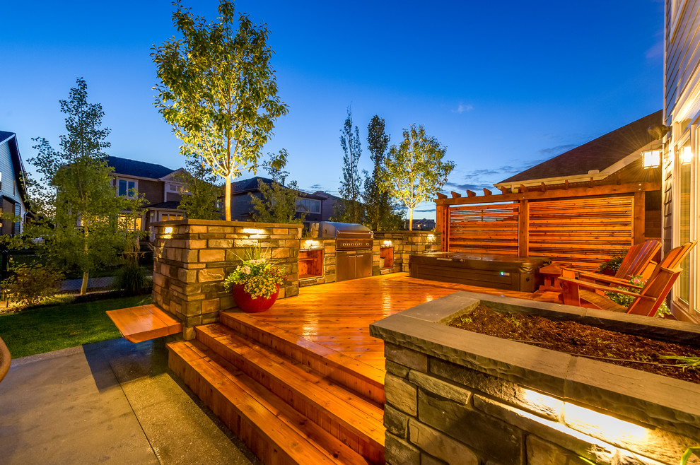 Mid-sized arts and crafts backyard deck in Calgary with an outdoor kitchen and no cover.