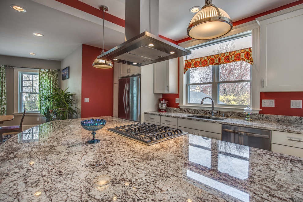 Mid-sized transitional galley light wood floor and beige floor eat-in kitchen photo in Boston with an undermount sink, shaker cabinets, white cabinets, granite countertops, red backsplash, stainless steel appliances and an island