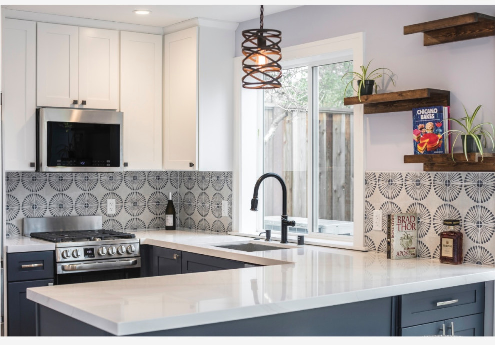 Example of a mid-sized minimalist kitchen design with a single-bowl sink, flat-panel cabinets, white cabinets, quartzite countertops, white backsplash, mosaic tile backsplash, stainless steel appliances and white countertops