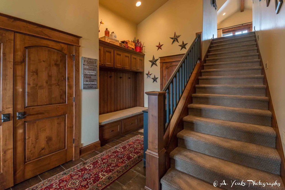 Example of a mid-sized mountain style carpeted straight staircase design with carpeted risers