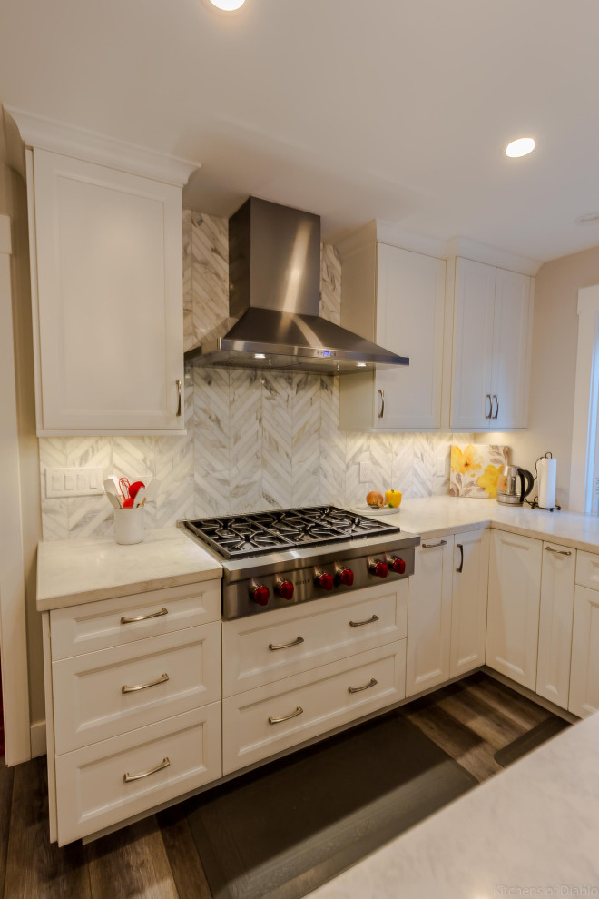 Open concept kitchen - large transitional u-shaped medium tone wood floor and gray floor open concept kitchen idea in San Francisco with an undermount sink, recessed-panel cabinets, white cabinets, quartz countertops, white backsplash, marble backsplash, stainless steel appliances, an island and white countertops