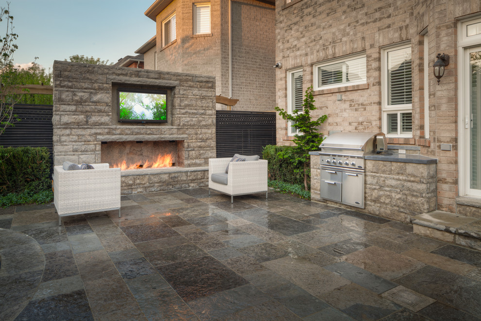Inspiration for a small transitional patio in Toronto with an outdoor kitchen.