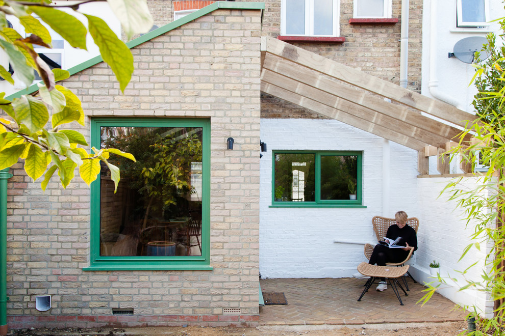 Design ideas for a small contemporary backyard deck in London with a pergola.