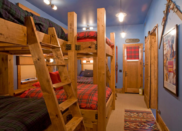 Photo of a mid-sized country gender-neutral kids' room in Denver with blue walls, carpet and brown floor.