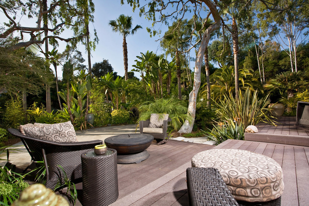 Example of a large island style backyard deck design in San Diego with no cover