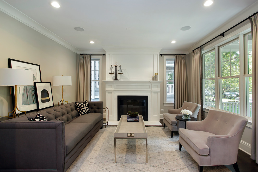 This is an example of a mid-sized transitional formal living room in Chicago with grey walls, dark hardwood floors, a standard fireplace and no tv.