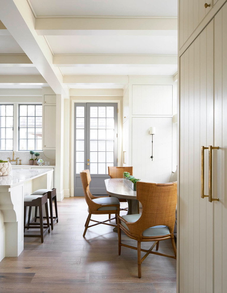 Large transitional u-shaped medium tone wood floor eat-in kitchen photo in Dallas with an island, flat-panel cabinets, white cabinets, quartz countertops, an undermount sink, multicolored backsplash, mosaic tile backsplash and paneled appliances