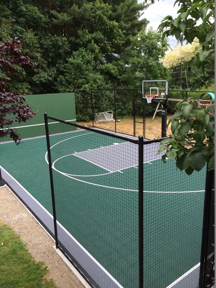 Mid-sized traditional backyard partial sun outdoor sport court in Boston with with outdoor playset and gravel.