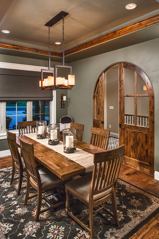 Traditional separate dining room in Denver with grey walls, dark hardwood floors and brown floor.