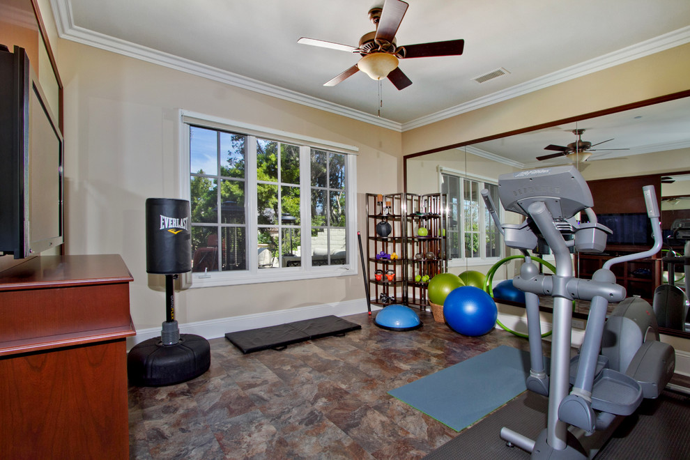 Inspiration for a mid-sized traditional multipurpose gym in San Diego with beige walls and vinyl floors.