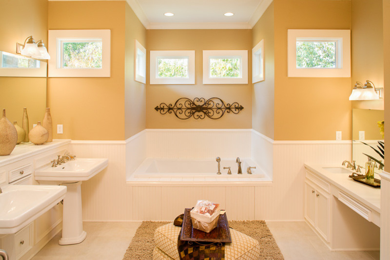 Example of a large transitional master white tile white floor drop-in bathtub design in Denver with recessed-panel cabinets, white cabinets, yellow walls and a pedestal sink