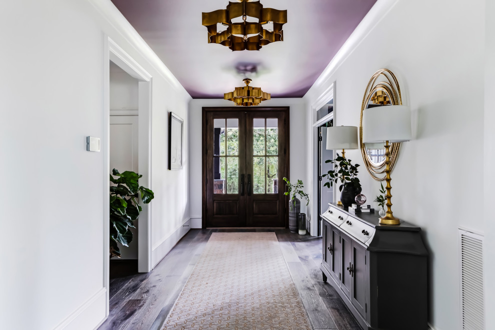 Inspiration for a country entryway in Raleigh with white walls, dark hardwood floors, a double front door, a dark wood front door and brown floor.