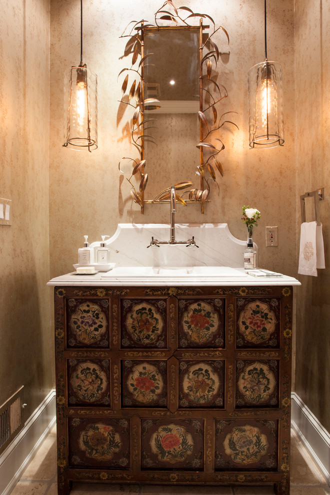 Mid-sized transitional powder room in Philadelphia with furniture-like cabinets, beige walls, limestone floors, marble benchtops and a drop-in sink.