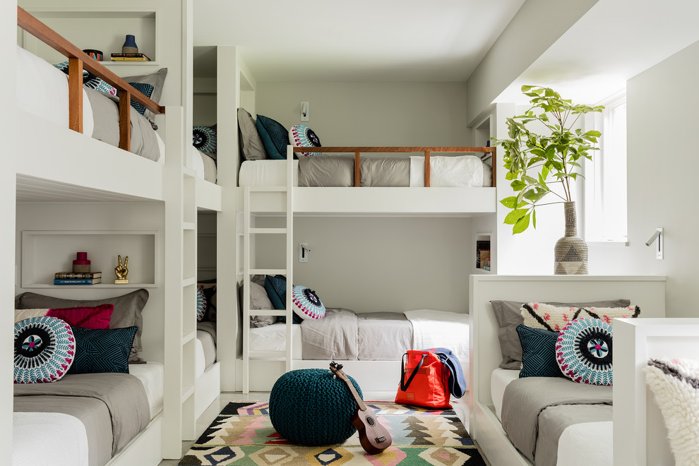 This is an example of a mid-sized beach style gender-neutral kids' bedroom for kids 4-10 years old in Boston with white walls.