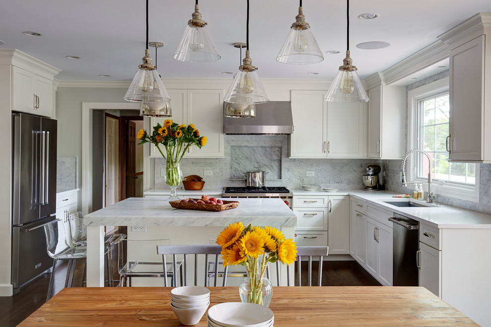 Inspiration for a mid-sized transitional u-shaped eat-in kitchen in Chicago with shaker cabinets, white cabinets, marble benchtops, with island, a single-bowl sink, white splashback, stainless steel appliances, medium hardwood floors and subway tile splashback.