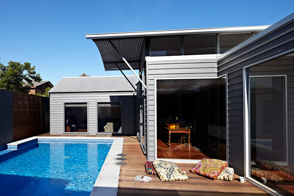 Photo of a small contemporary backyard rectangular natural pool in Melbourne with decking.