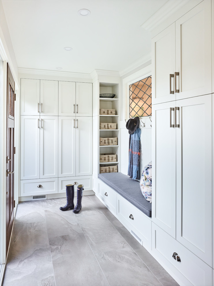 Mid-sized modern mudroom in Other with white walls, a single front door, a brown front door and grey floor.