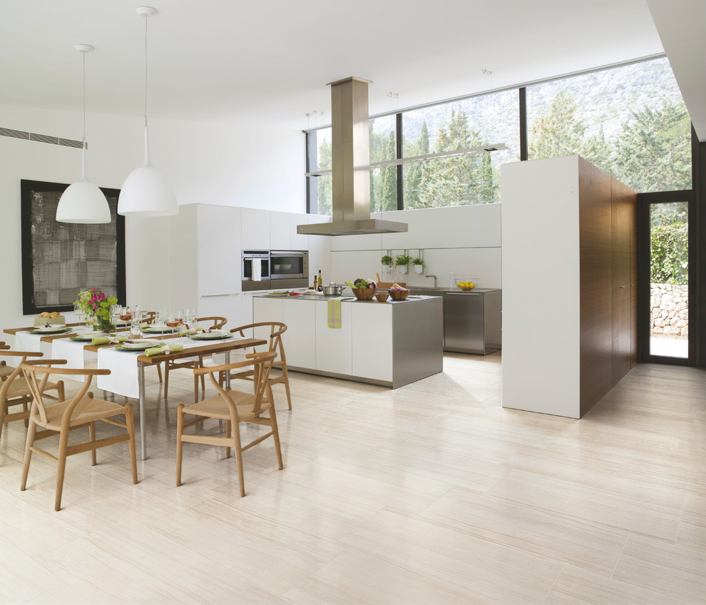 Design ideas for a mid-sized modern u-shaped eat-in kitchen in Chicago with flat-panel cabinets, white cabinets, stainless steel appliances, a drop-in sink, solid surface benchtops, white splashback, stone slab splashback, light hardwood floors and with island.