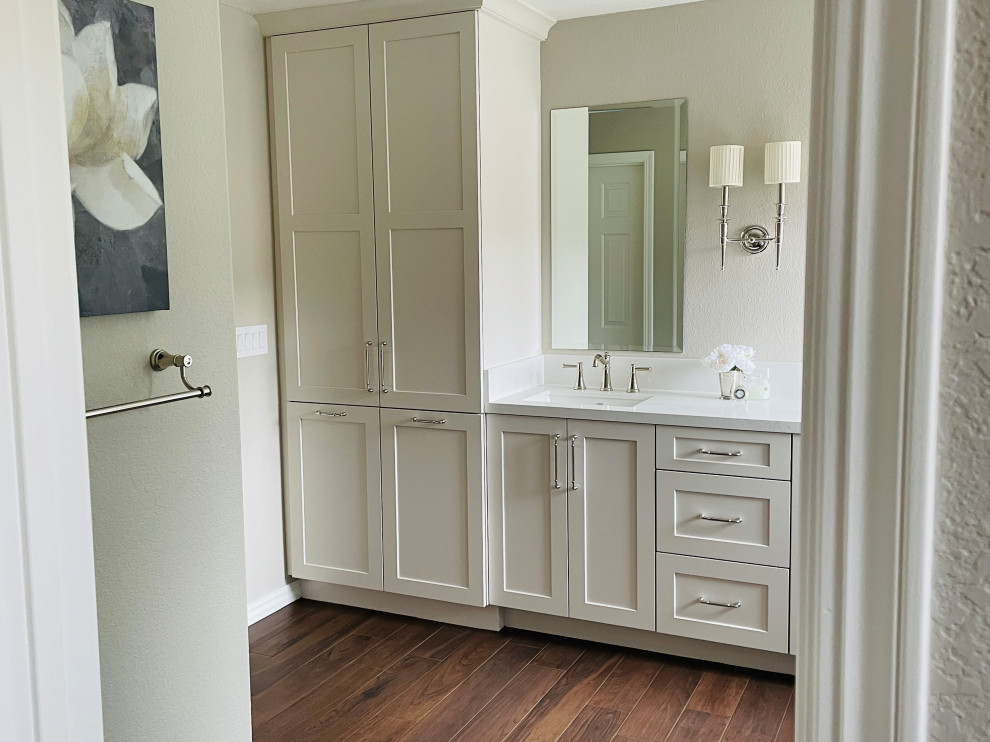 Inspiration for a medium sized classic ensuite bathroom in San Francisco with shaker cabinets, white cabinets, a submerged bath, a corner shower, white tiles, ceramic tiles, white walls, laminate floors, a submerged sink, engineered stone worktops, brown floors, a hinged door, white worktops, a shower bench, double sinks and a built in vanity unit.