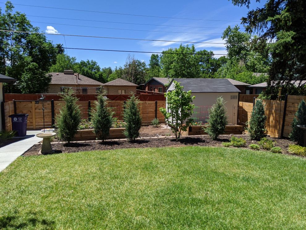 Photo of a mid-sized country backyard full sun garden in Denver with with privacy feature and a wood fence.