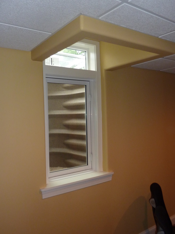 Inspiration for a large transitional look-out carpeted basement remodel with yellow walls