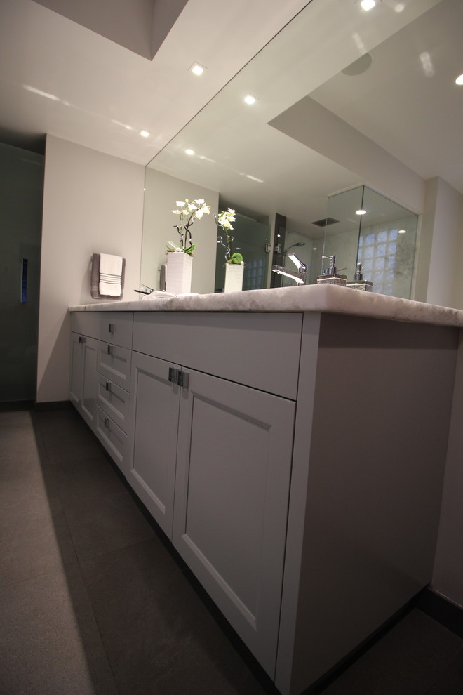 Home design - large transitional master gray tile and porcelain tile porcelain tile home design idea in Vancouver with shaker cabinets, gray cabinets, an undermount tub, a one-piece toilet, gray walls, an undermount sink and quartzite countertops