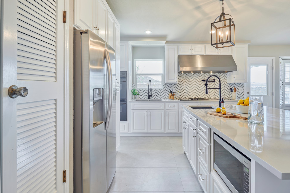 Example of a small transitional l-shaped porcelain tile and gray floor eat-in kitchen design with an undermount sink, beaded inset cabinets, white cabinets, quartzite countertops, multicolored backsplash, glass sheet backsplash, black appliances, a peninsula and white countertops