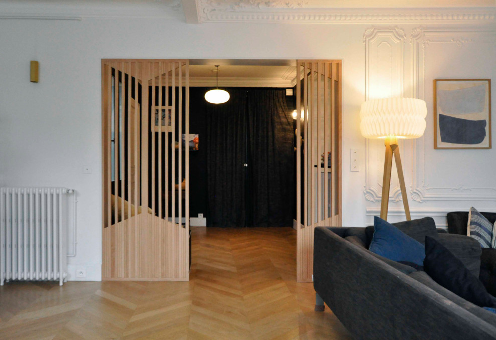 Design ideas for a large contemporary foyer in Paris with blue walls, medium hardwood floors, a double front door, a blue front door and beige floor.