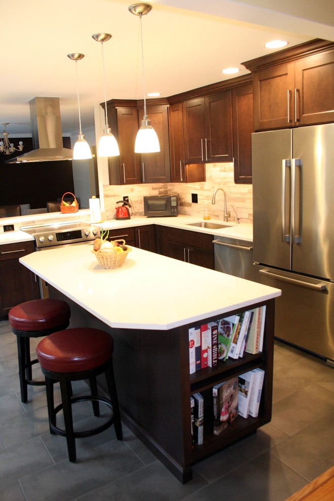 Example of a mid-sized transitional l-shaped porcelain tile eat-in kitchen design in DC Metro with an undermount sink, flat-panel cabinets, dark wood cabinets, quartzite countertops, gray backsplash, stone tile backsplash, stainless steel appliances and an island