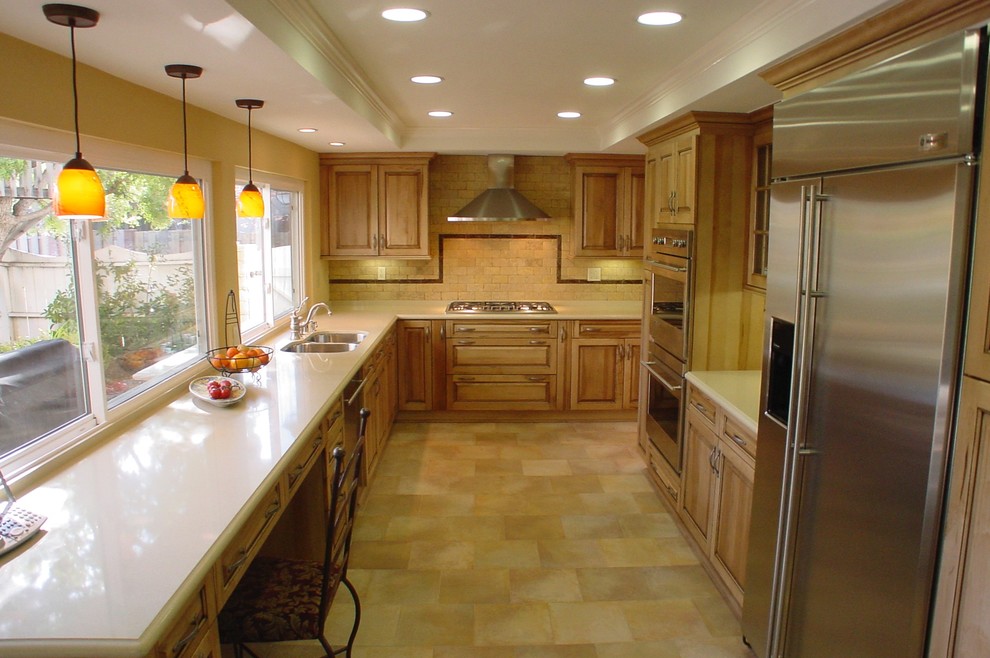 Large transitional ceramic tile kitchen photo in Los Angeles with a double-bowl sink, raised-panel cabinets, light wood cabinets, quartz countertops, beige backsplash, subway tile backsplash, stainless steel appliances and no island
