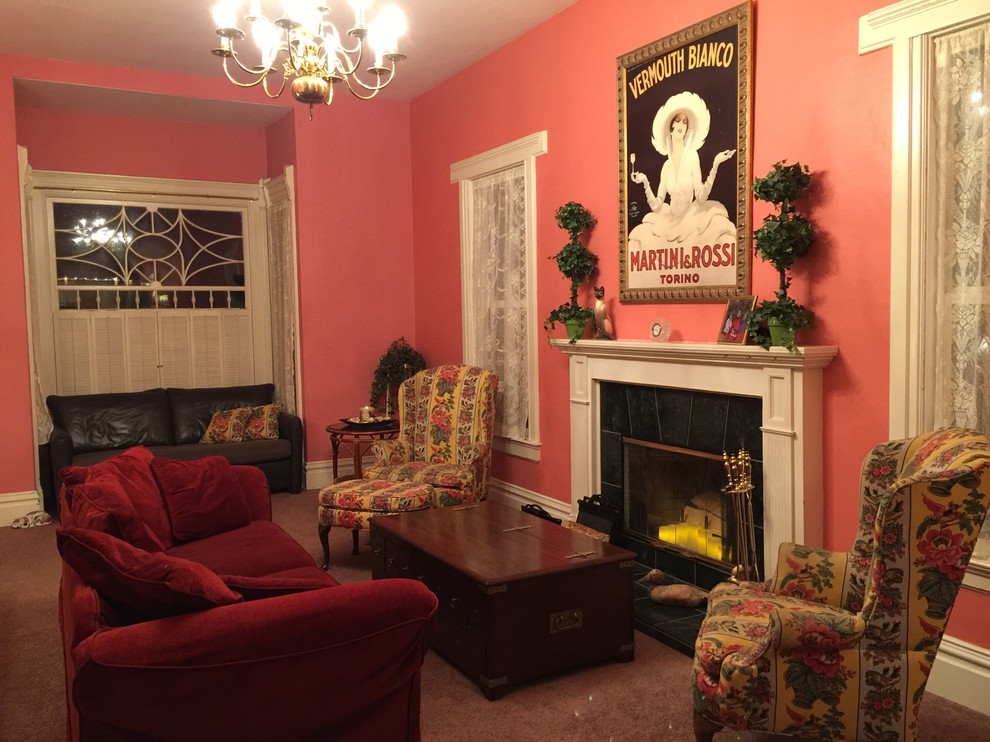 This is an example of a large traditional open concept living room in San Francisco with pink walls, carpet, a standard fireplace, a plaster fireplace surround and no tv.