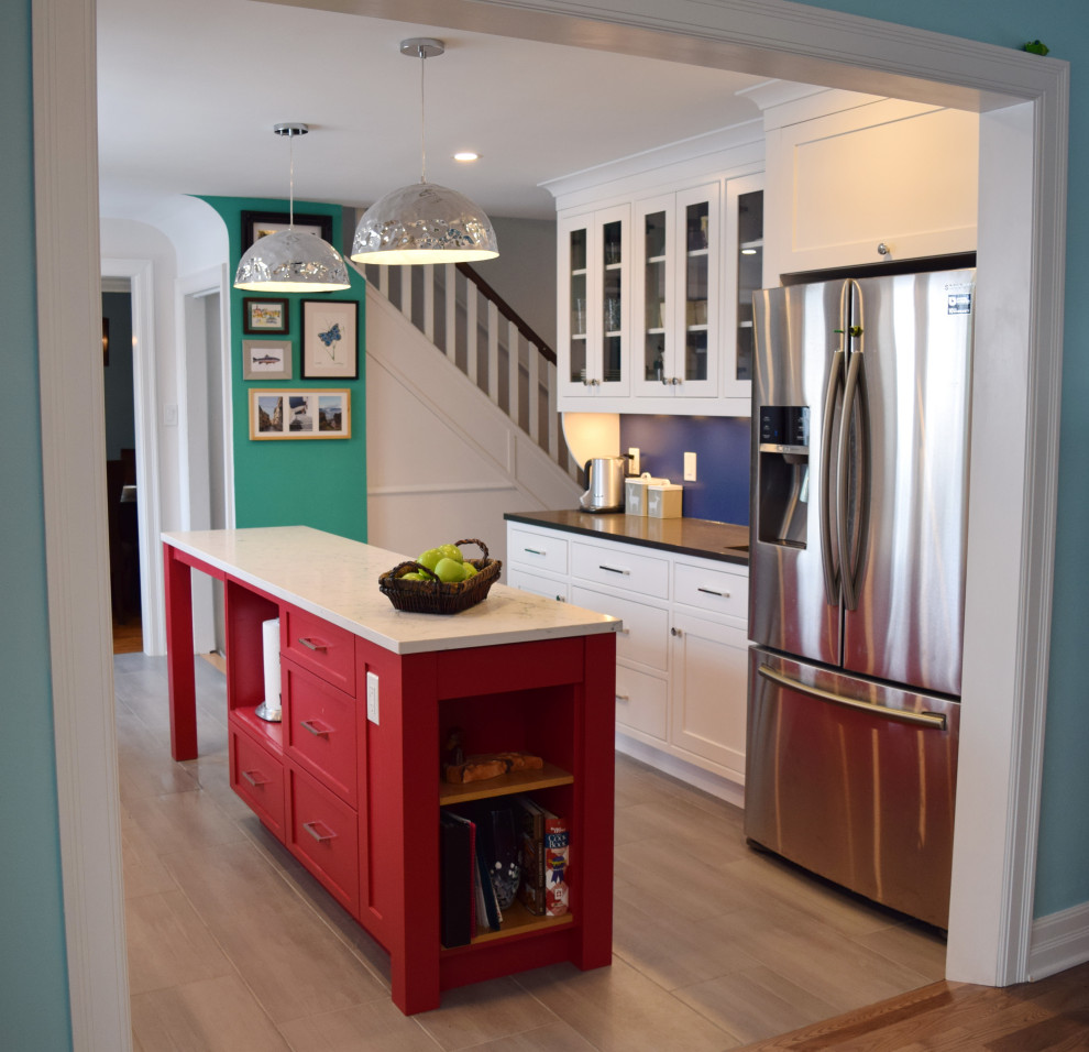 Inspiration for a small eclectic galley light wood floor and beige floor enclosed kitchen remodel in Ottawa with an undermount sink, shaker cabinets, white cabinets, quartz countertops, white backsplash, subway tile backsplash, stainless steel appliances, an island and white countertops