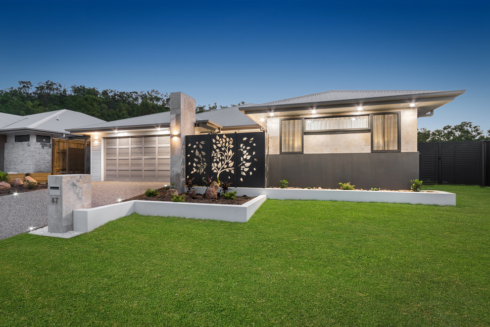Design ideas for a large modern one-storey beige house exterior in Townsville with a hip roof and a metal roof.