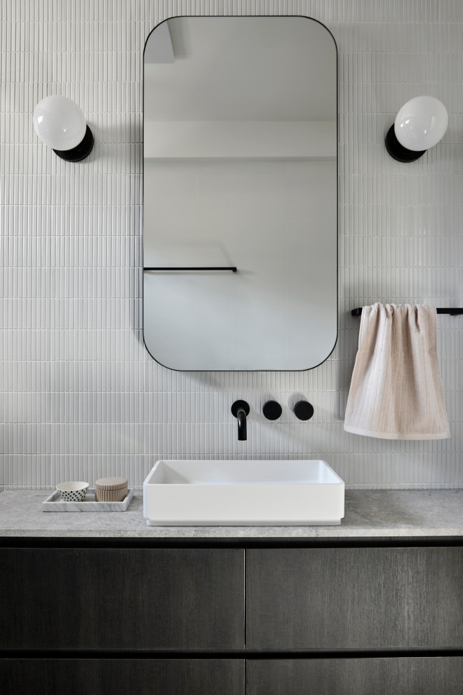 This is an example of a contemporary kids bathroom in Melbourne with grey cabinets, an open shower, a wall-mount toilet, gray tile, ceramic tile, white walls, a vessel sink, marble benchtops, grey floor, an open shower, grey benchtops, a single vanity and a floating vanity.