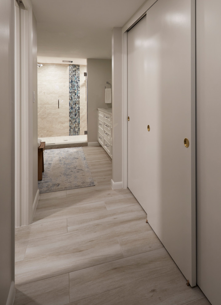 Alcove shower - mid-sized transitional master beige tile and porcelain tile porcelain tile, gray floor and double-sink alcove shower idea with recessed-panel cabinets, white cabinets, a one-piece toilet, gray walls, an undermount sink, quartz countertops, a hinged shower door, gray countertops and a built-in vanity