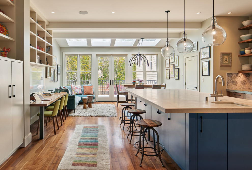 Photo of a transitional open plan kitchen in San Francisco with an undermount sink, multi-coloured splashback, medium hardwood floors, with island and white benchtop.