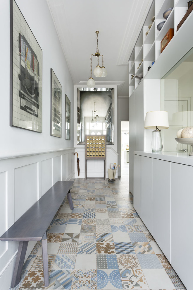 Photo of a transitional hallway in London with white walls.