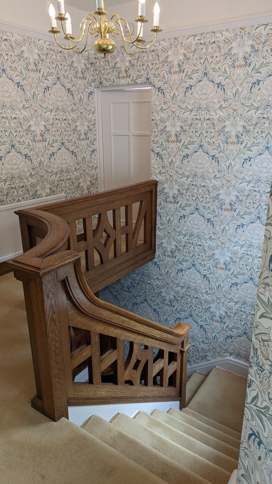 Inspiration for a traditional staircase in Other with wallpaper.