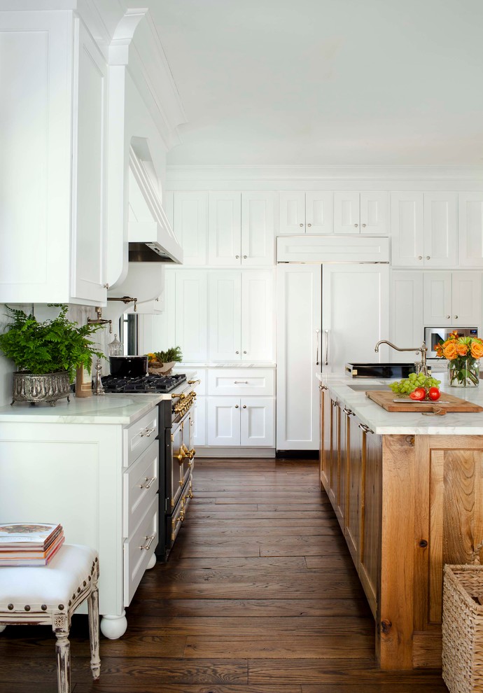 Mid-sized traditional l-shaped separate kitchen in Atlanta with an undermount sink, recessed-panel cabinets, white cabinets, marble benchtops, white splashback, stone slab splashback, panelled appliances, medium hardwood floors and with island.